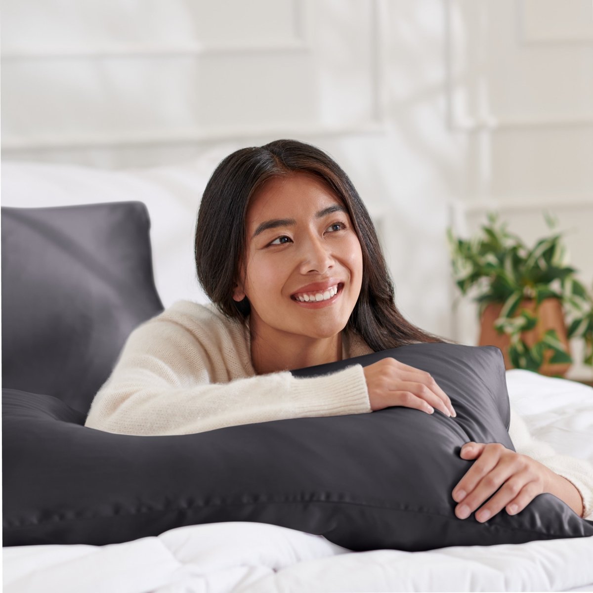 Woman lying on abed with a silk pillowcase