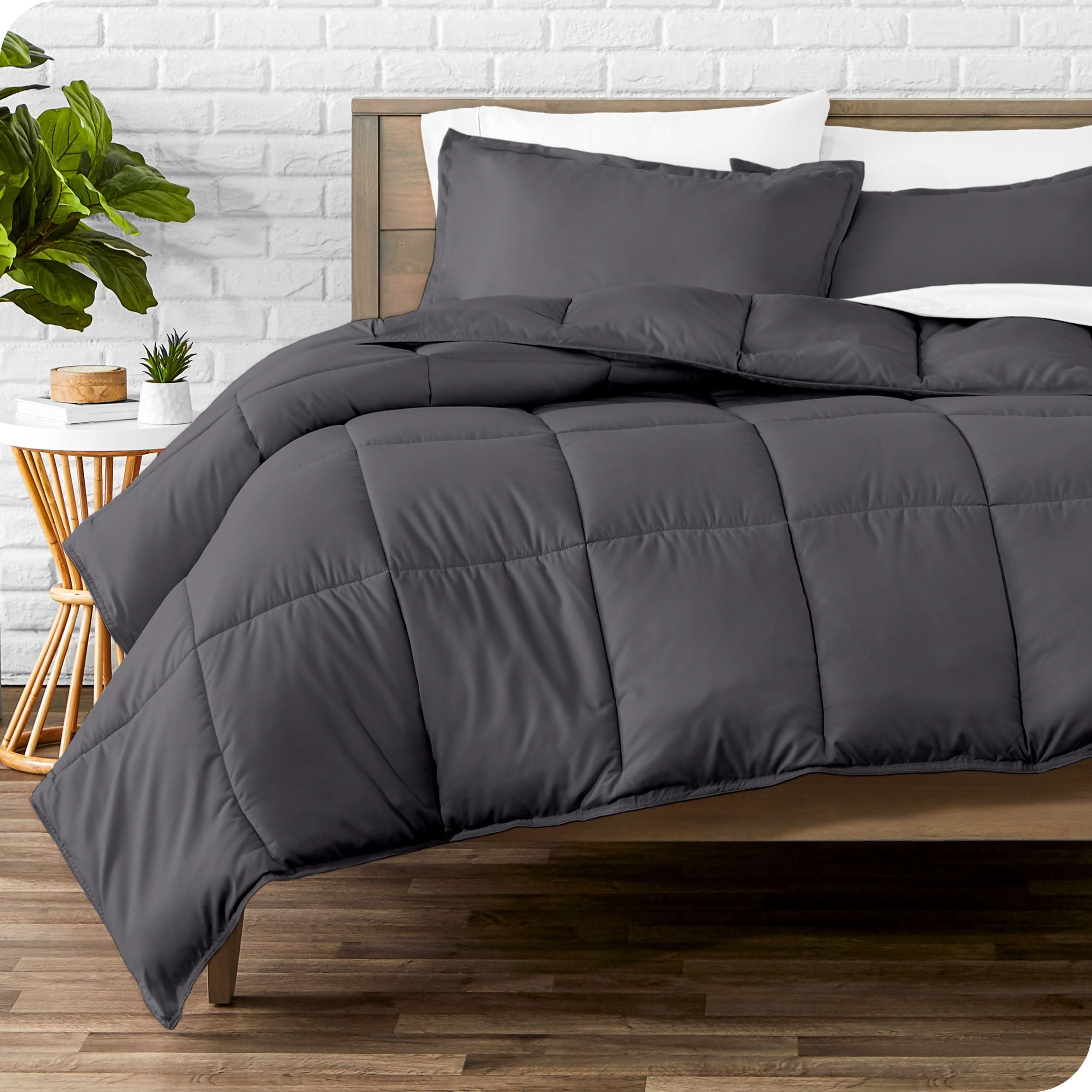 A modern bed with a down alternative comforter set on it