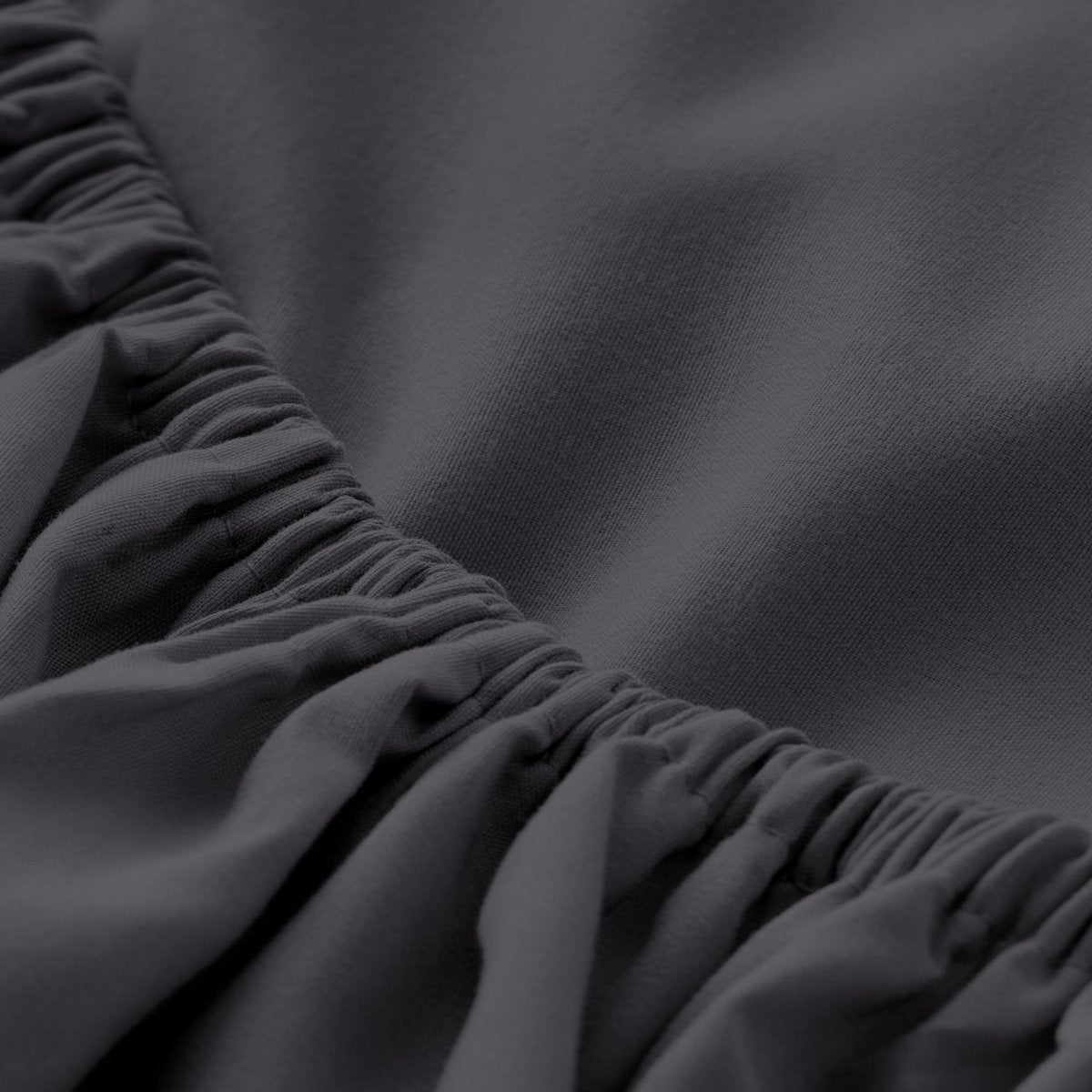 A close-up of a fitted sheet with elasticized edge.