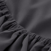 A close-up of a fitted sheet with elasticized edge.