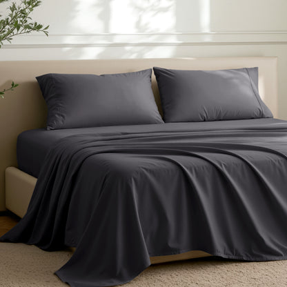 Microfiber sheets on a bed in a well-lit room with a plant.