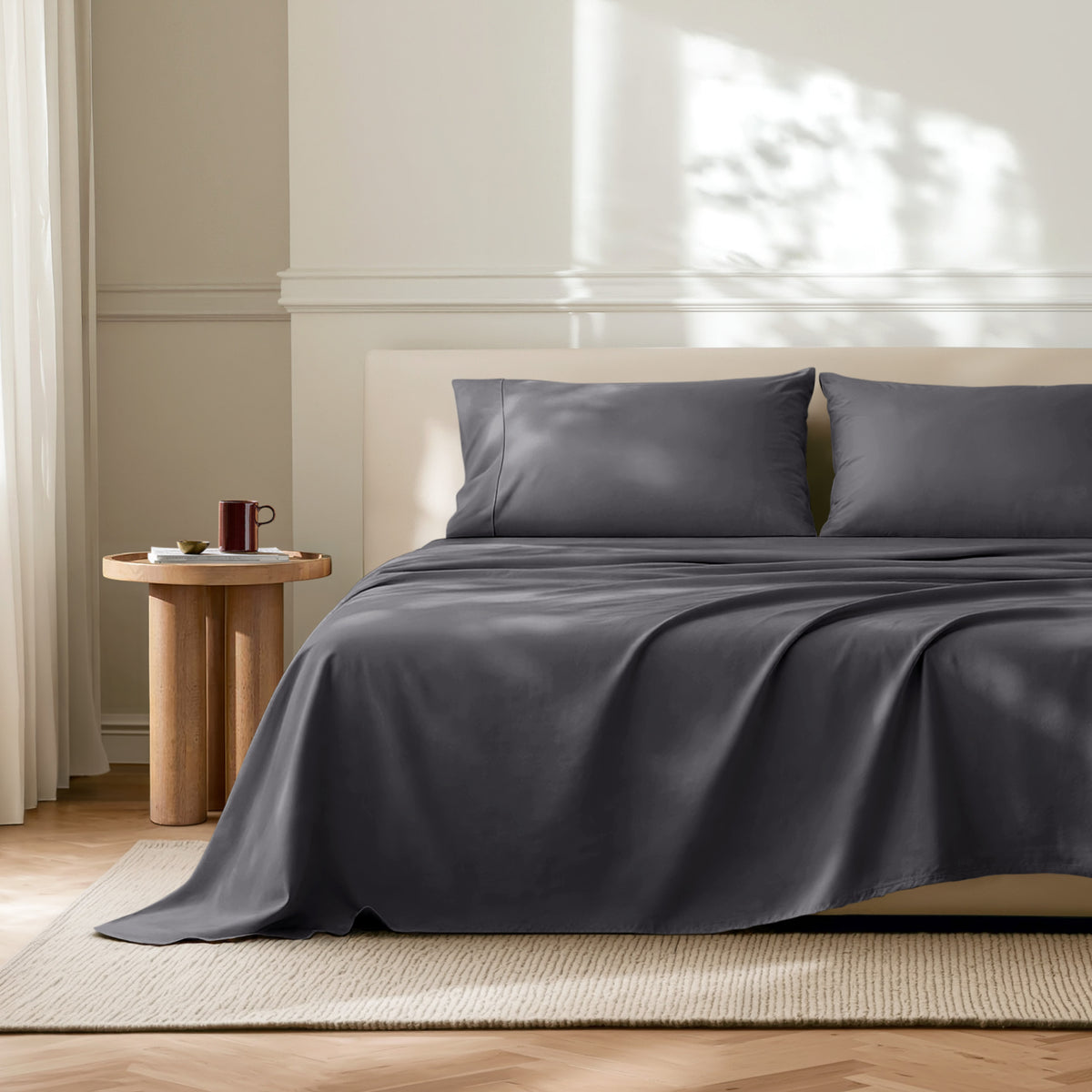 Neatly made bed with microfiber bedding in a bright bedroom.