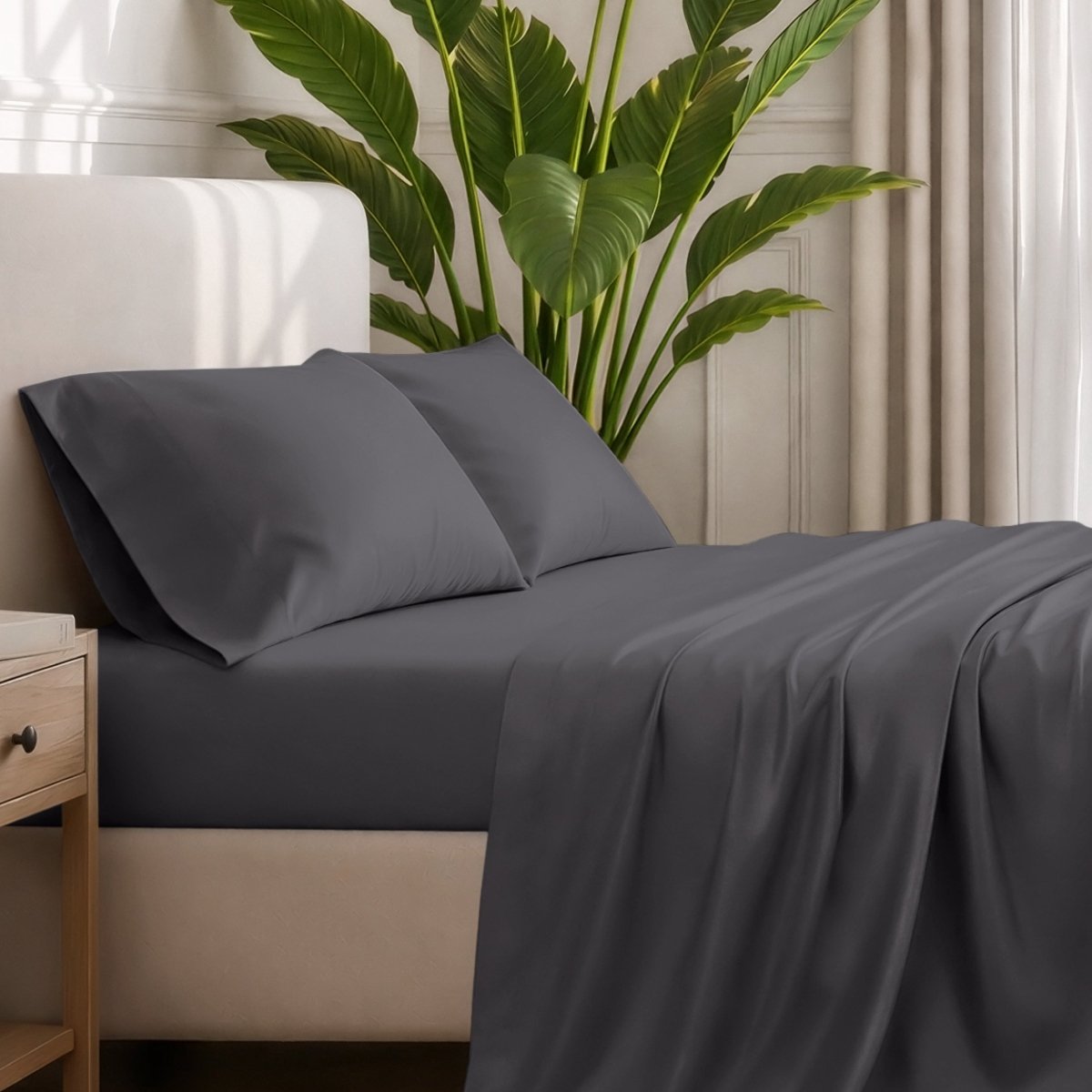 Ultra-soft sheets and pillowcases on a bed with a plant in the background