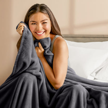 A woman cuddling with a microplush blanket