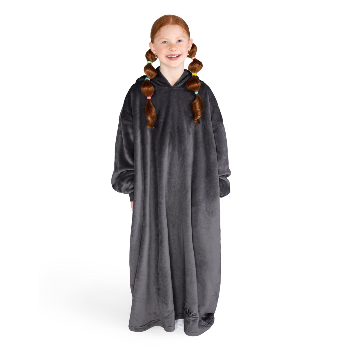 A girl is standing while wearing a long microplush wearable blanket