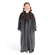 A girl is standing while wearing a long microplush wearable blanket
