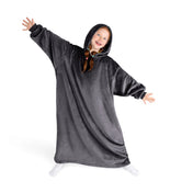 A girl has a hooded blanket on that is long enough to cover her legs