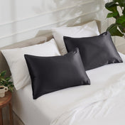 Satin pillowcases on a bed with white bedding