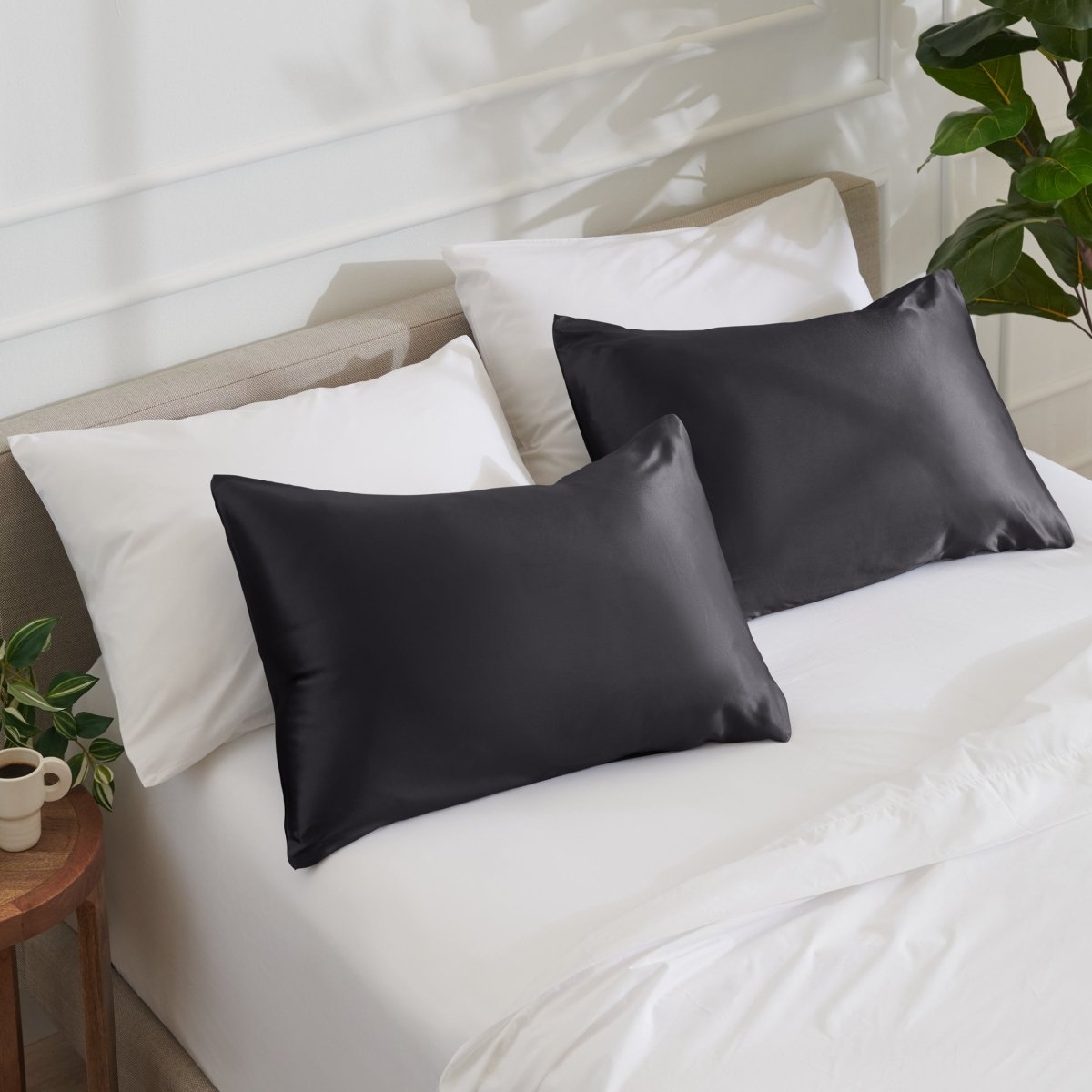 Satin pillowcases on a bed with white bedding