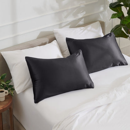 Satin pillowcases on a bed with white bedding