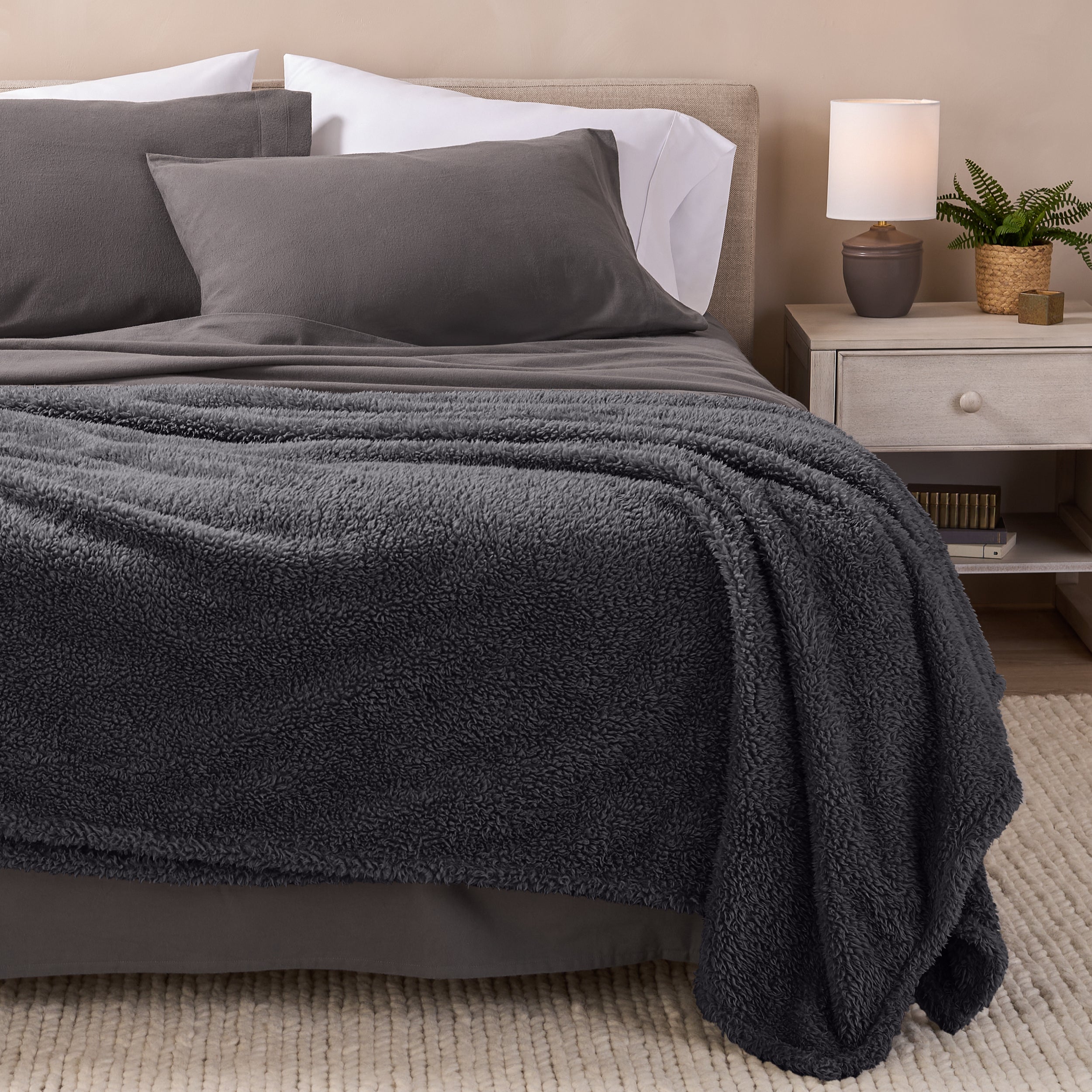 A double sided sherpa blanket on a bed