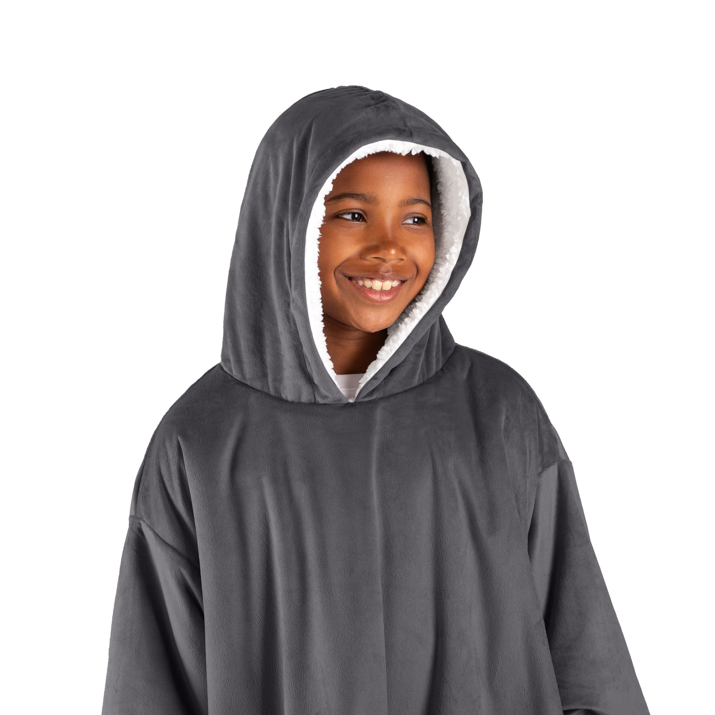 A boy has a wearable blanket on