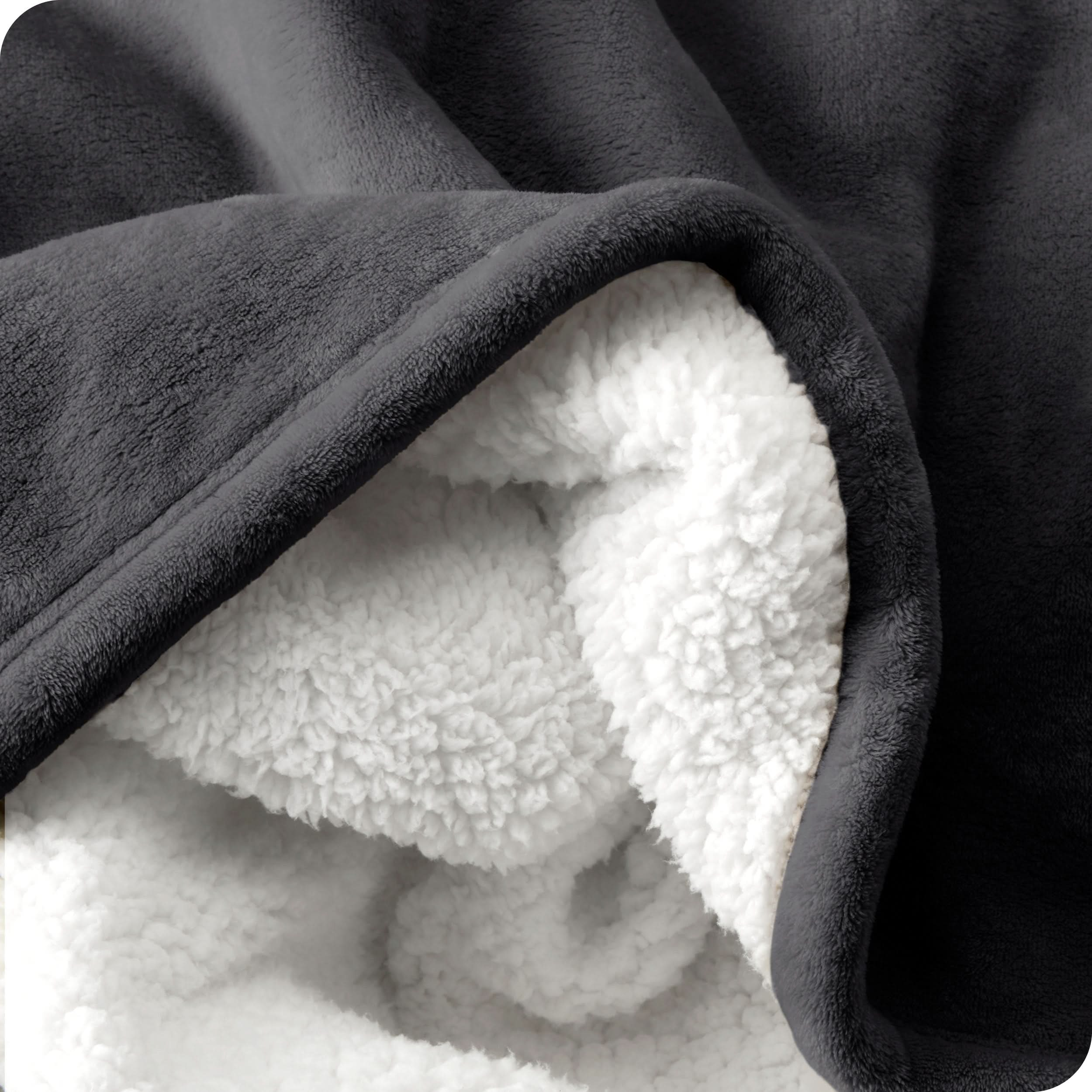 Close up of sherpa blanket showing texture of velvety soft side and sherpa backing