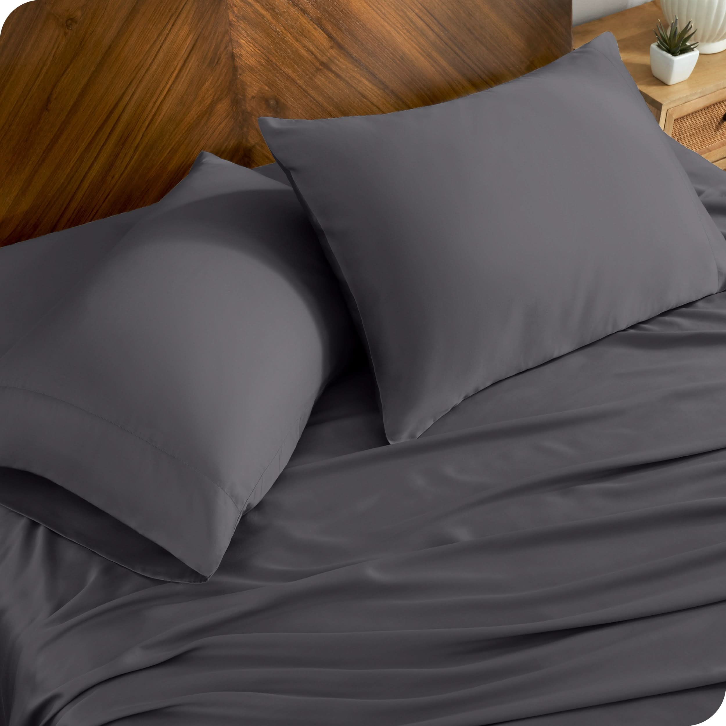 TENCEL™ pillowcases on pillows near a wooden headboard