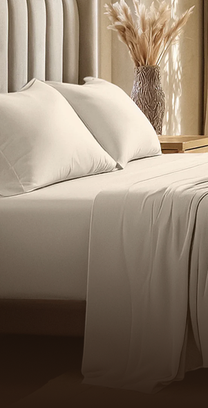 Close-up of a neatly made bed with white pillows and linens