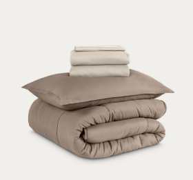 Folded stack of beige bed sheets, product photo