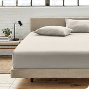 Bedroom scene with organic cotton fitted sheet and pillowcases on a bed