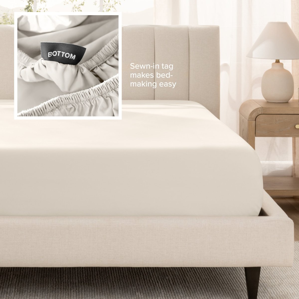 Sateen fitted sheet on a bed with a close-up of a sewn-in tag, set in a bedroom.