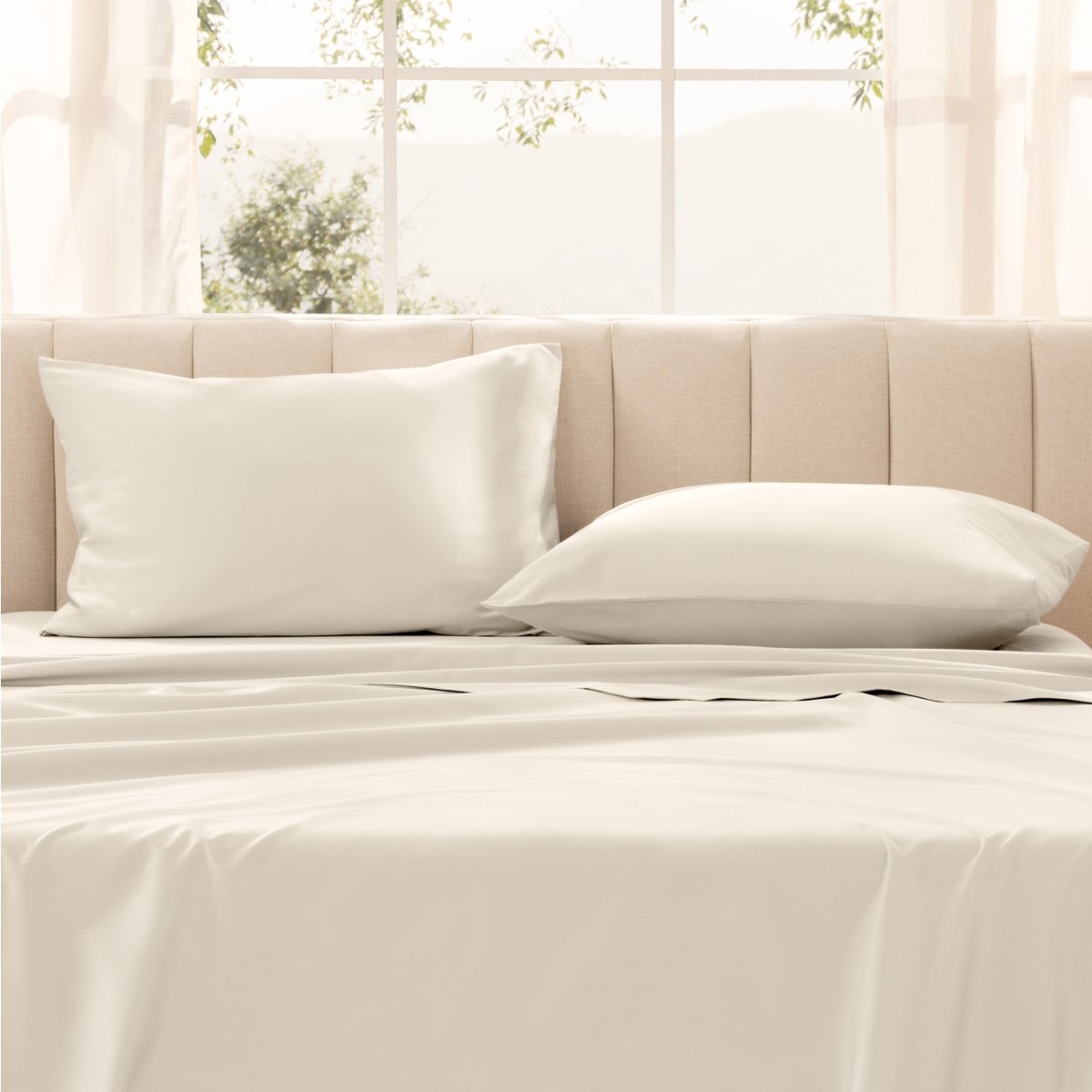 Pillows on a bed with in a bright room.