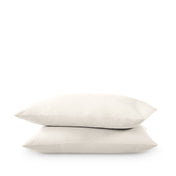 Two pillows stacked on a white background