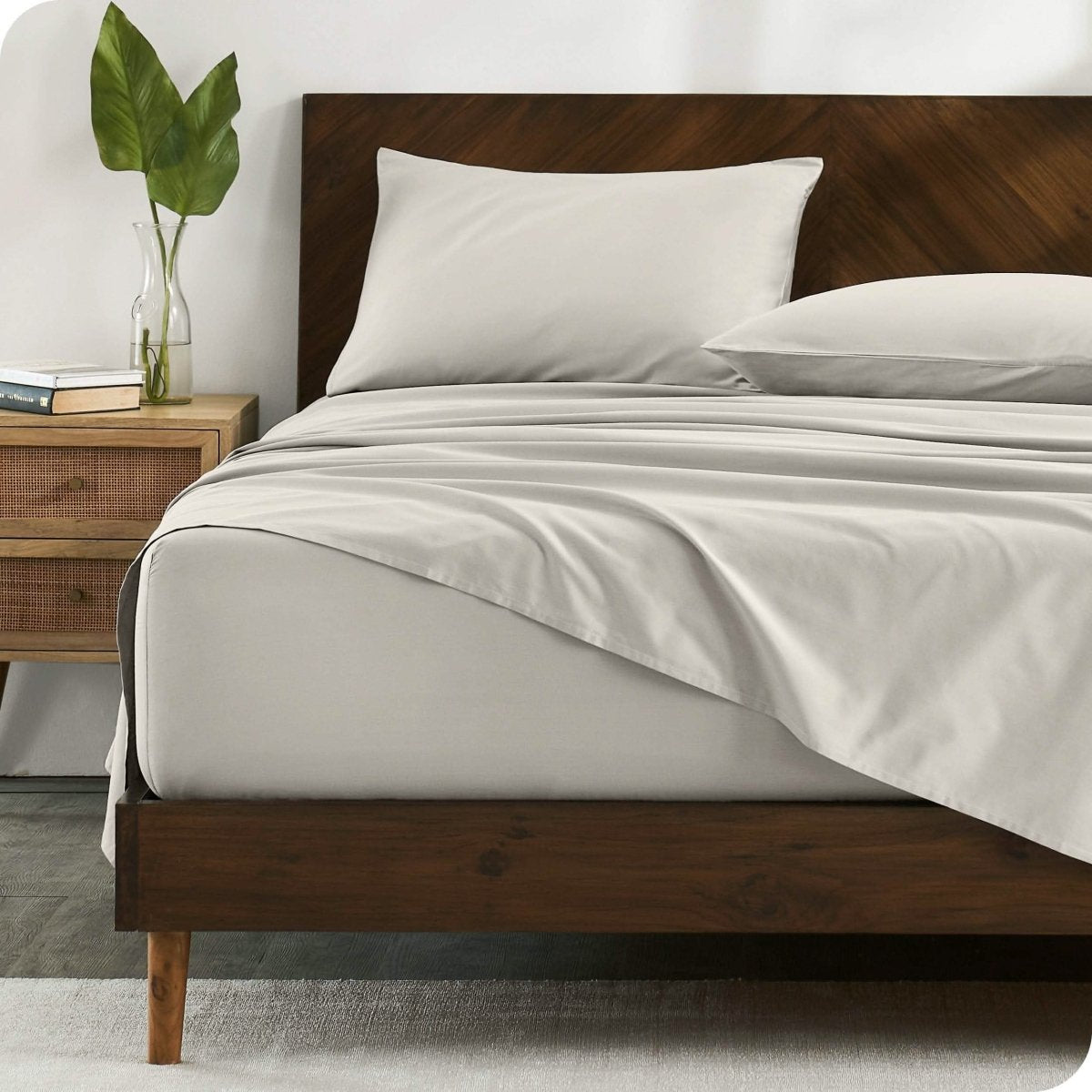 A bed made with organic cotton sateen sheets