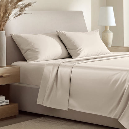 Sateen bedding set including a fitted sheet and two matching pillowcases on a bed.