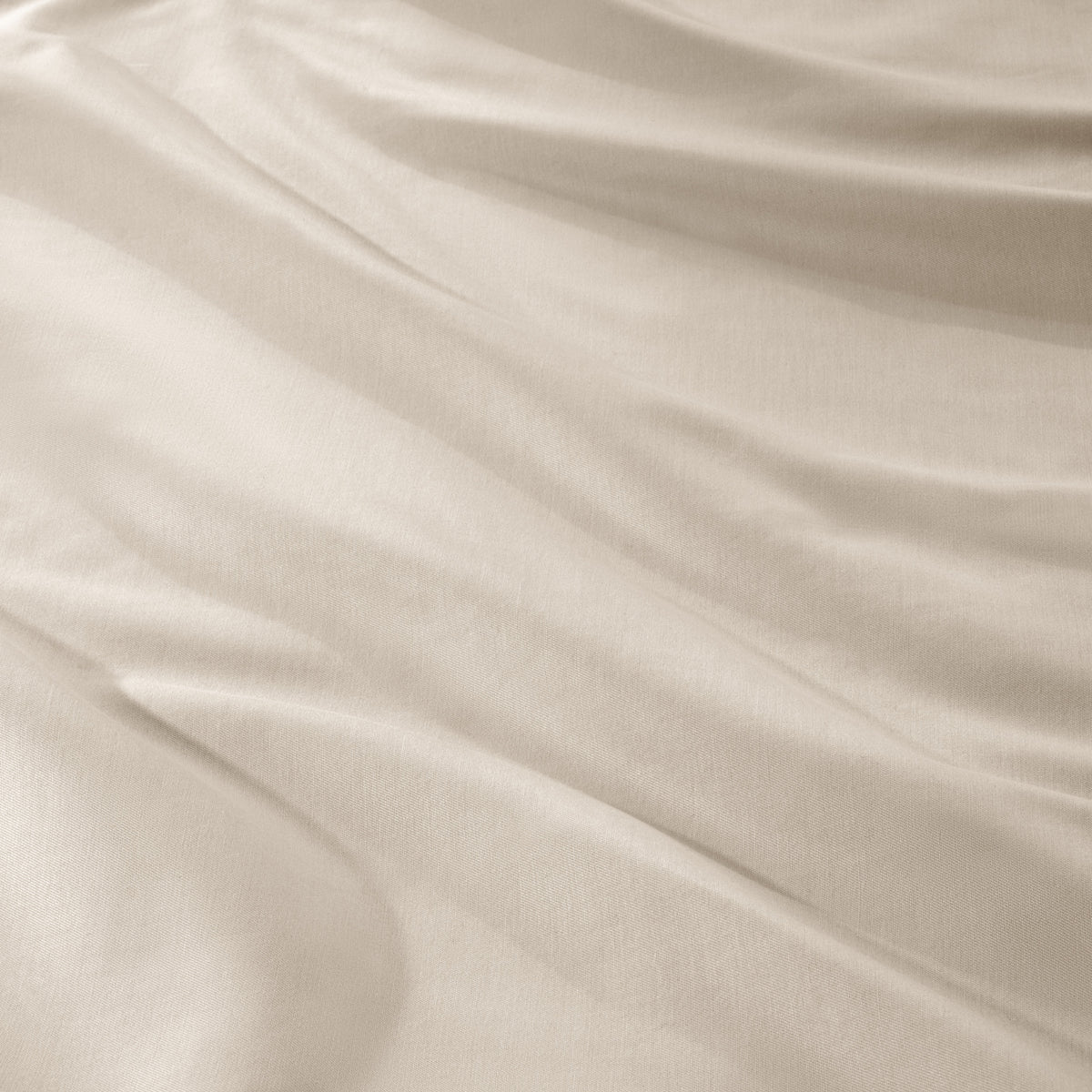 A close-up of draped sateen fabric with soft folds and a smooth texture.