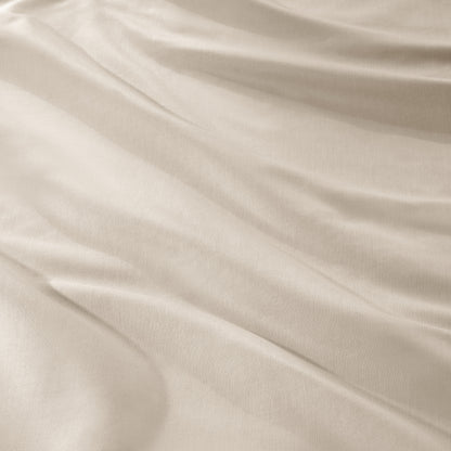 A close-up of draped sateen fabric with soft folds and a smooth texture.