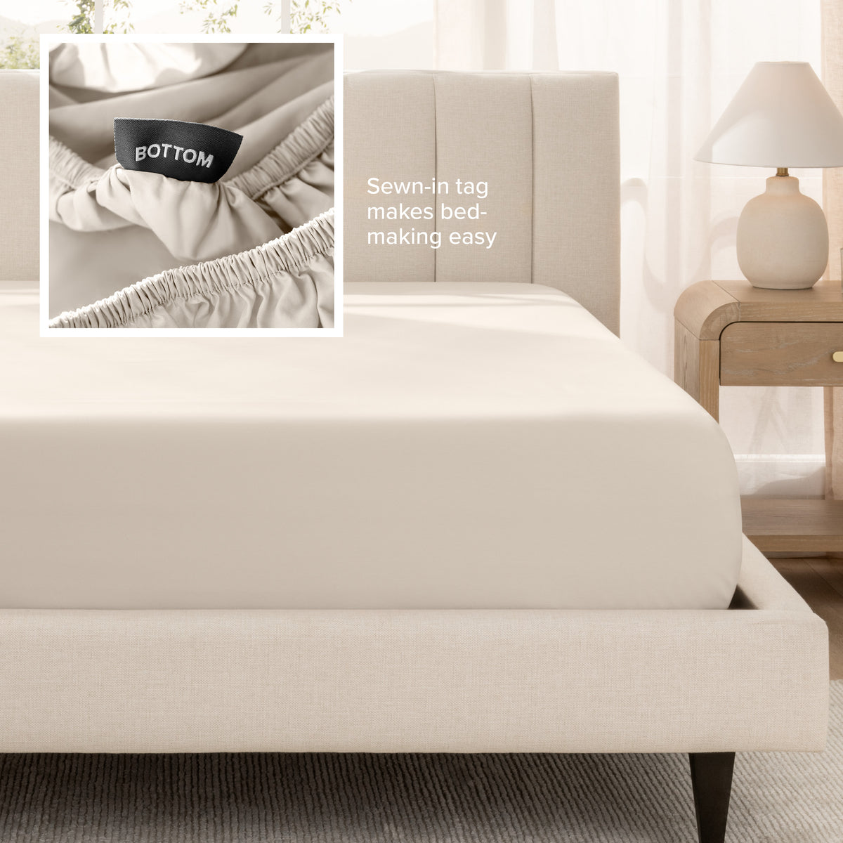 A fitted bed sheet shown on a bed. Text on the image says the sewn-in tag makes bed-making easy.