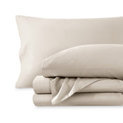 A sateen sheet set folded and stacked on a white background.