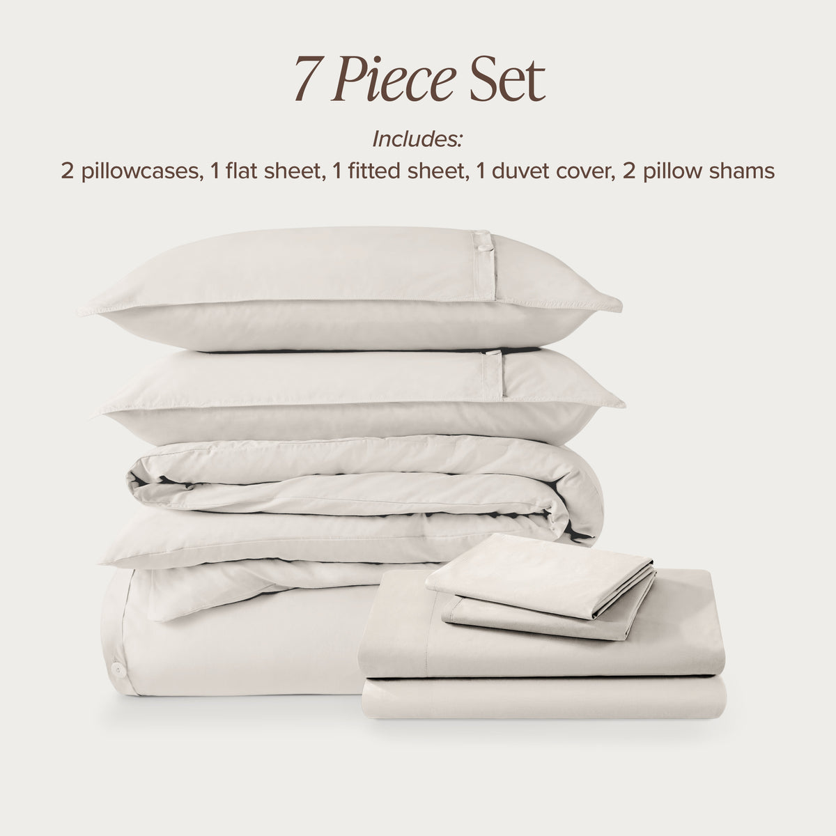 7-piece percale bedding set with pillowcases, flat sheet, fitted sheet, duvet cover, and pillow shams on a light background.