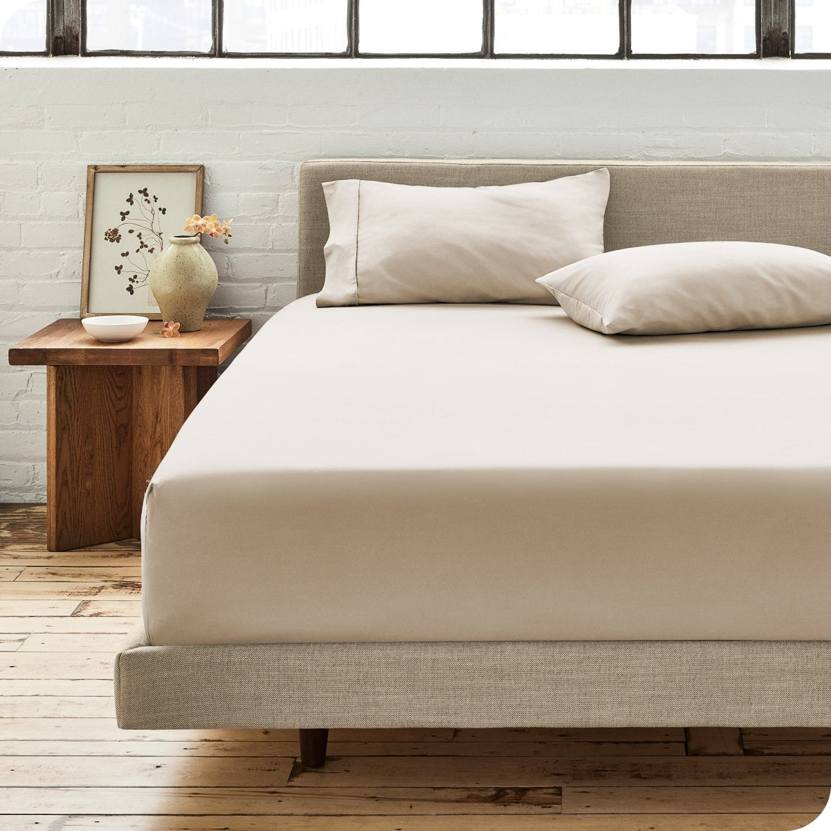 Modern bedroom with bed showing percale fitted sheet