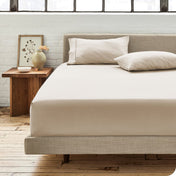 Modern bedroom with bed showing percale fitted sheet