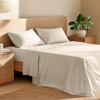 Bed with percale bedding and wooden headboard in a bedroom setting