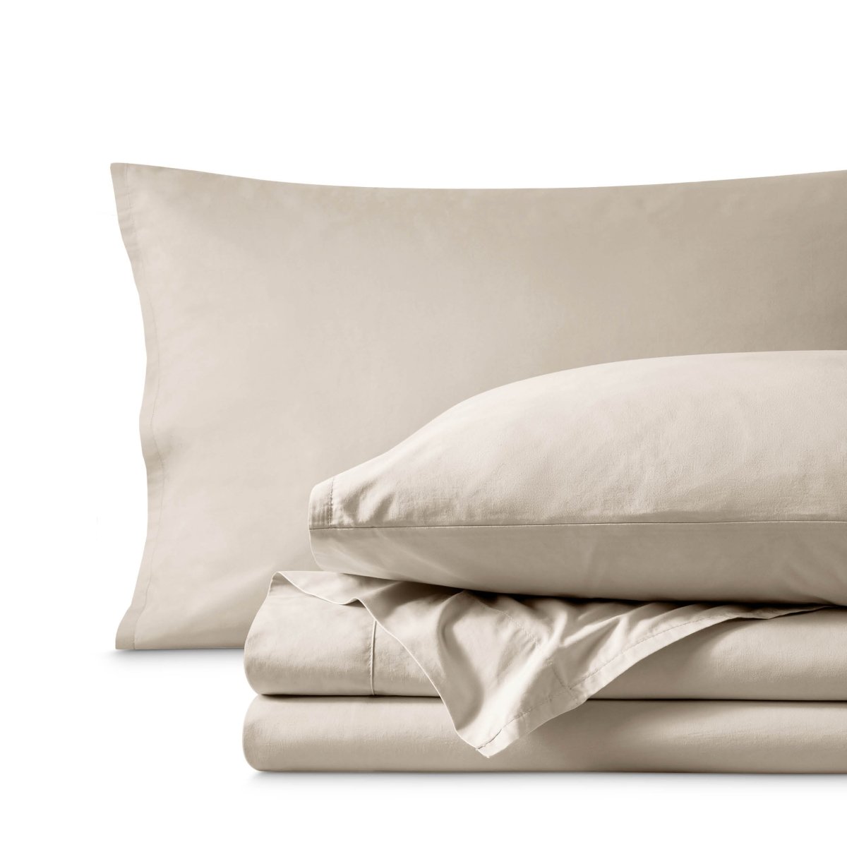 Percale bedding set including pillowcases and folded sheets arranged on a clean white background