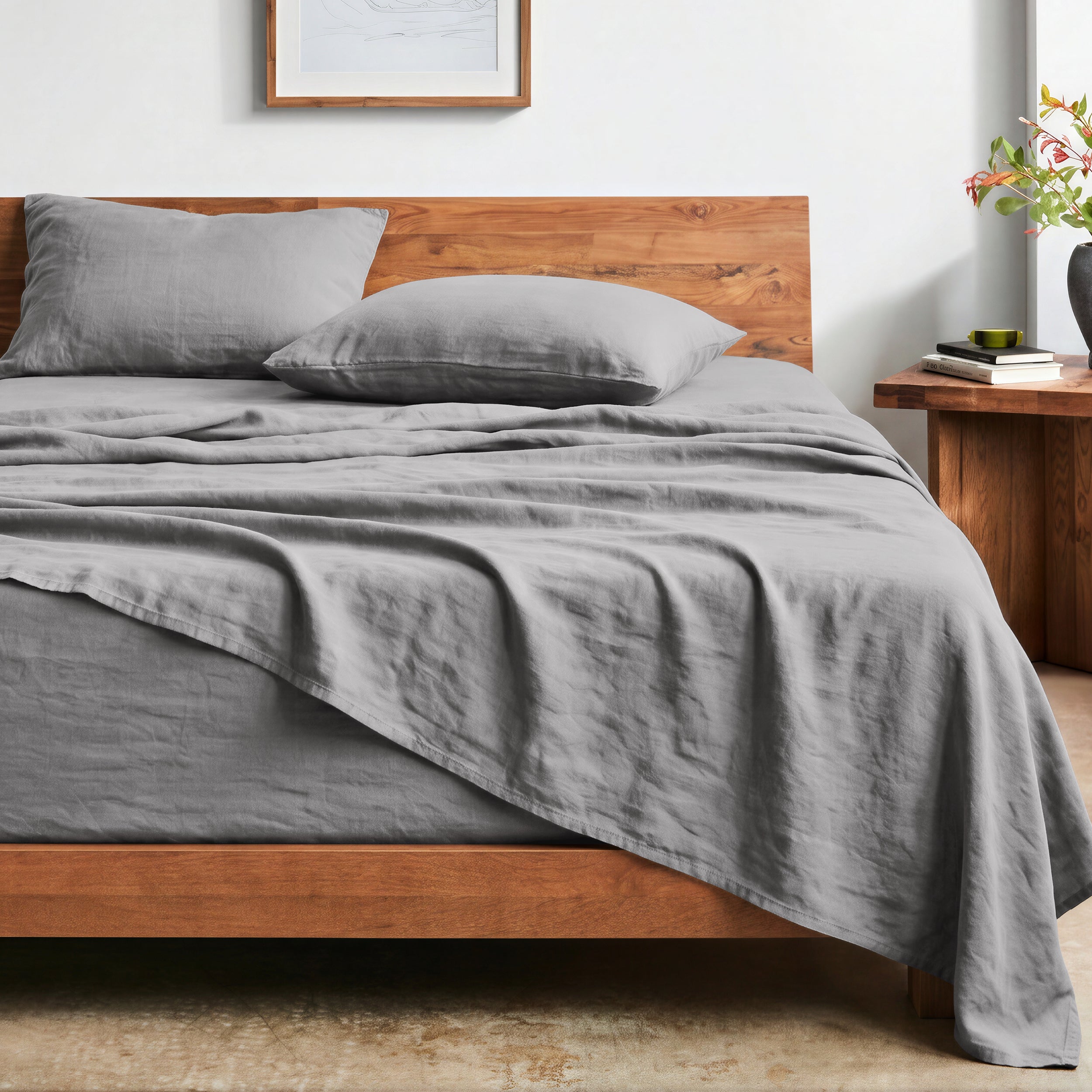 Bed with washed sheets and wooden headboard in a bedroom setting
