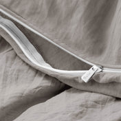 Close-up of a duvet cover with a zipper, featuring the brand Bare Home