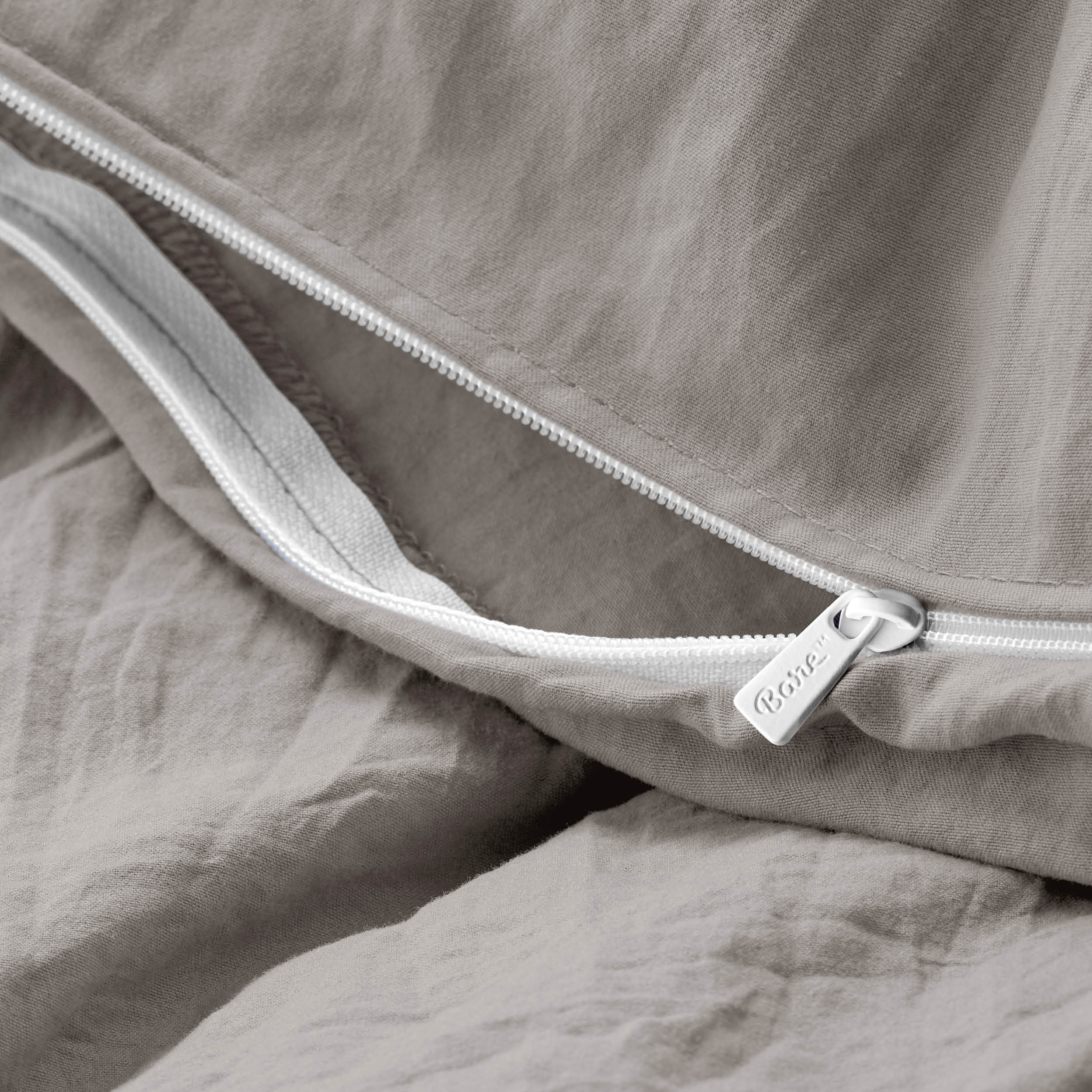 Close-up of a duvet cover with a zipper, featuring the brand Bare Home