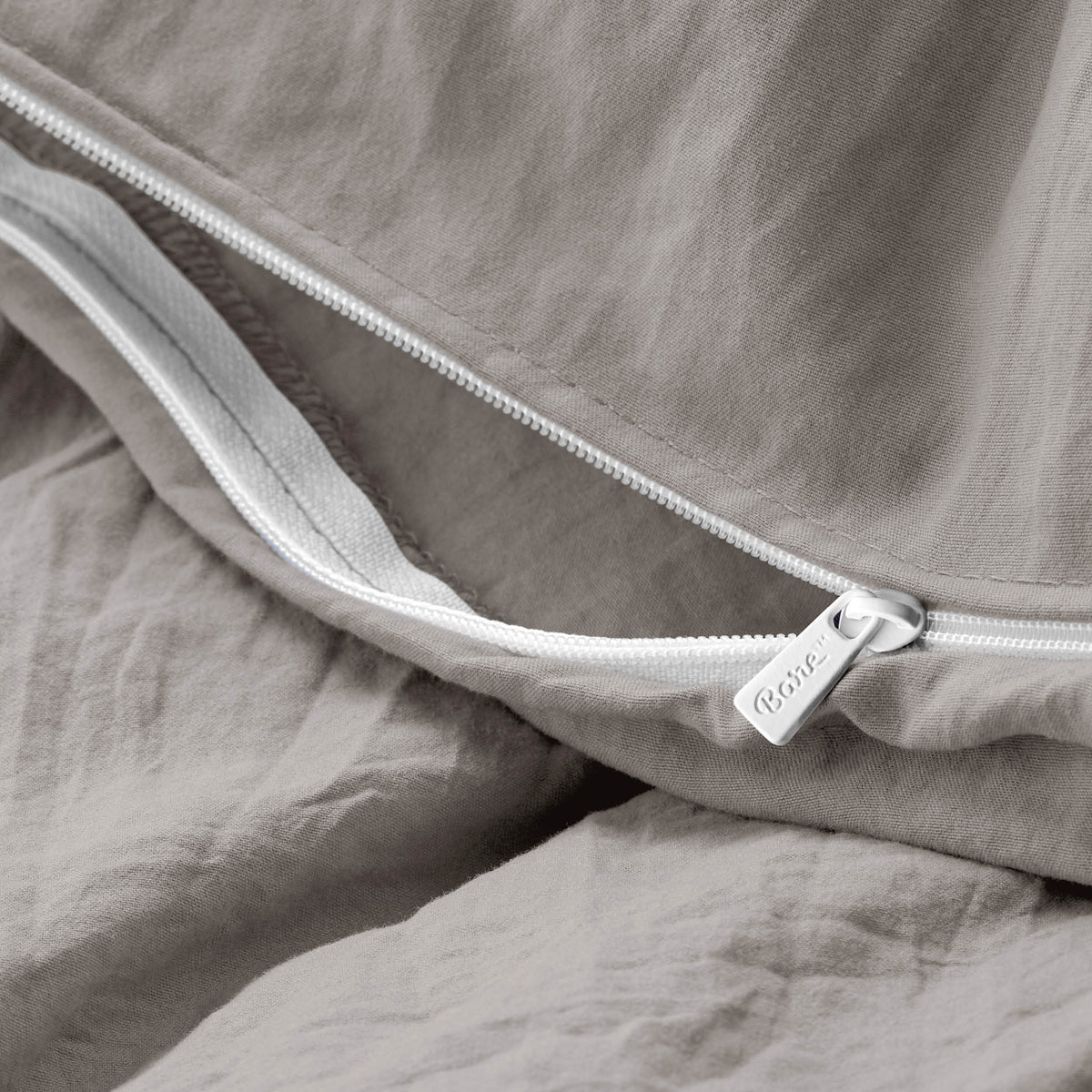 Close-up of a duvet cover with a zipper, featuring the brand Bare Home