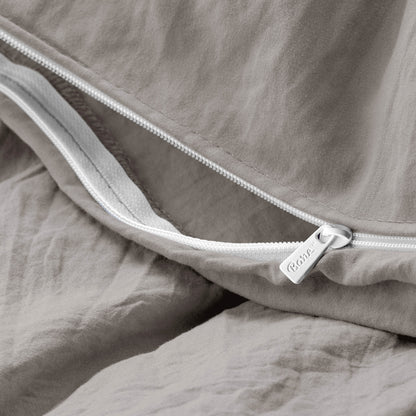 Close-up of a duvet cover with a zipper, featuring the brand Bare Home