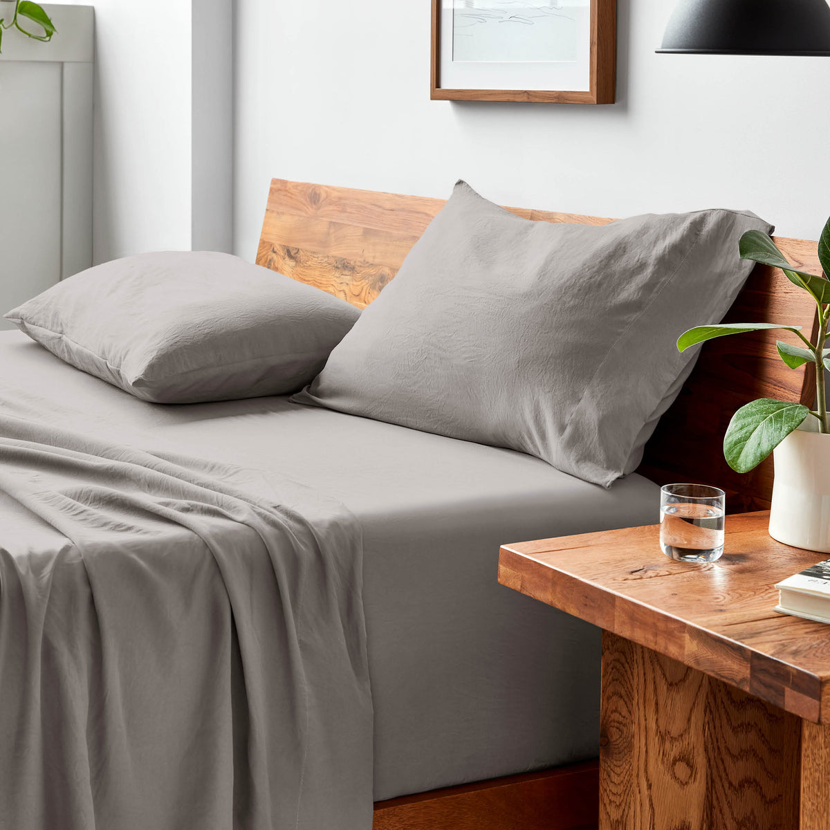 Bed with microfiber bedding and pillows in a bedroom setting