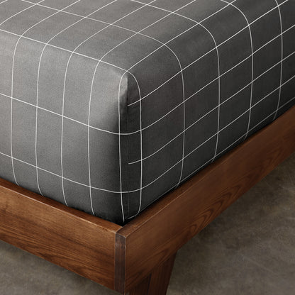 The corner of a mattress with a printed fitted sheet on it