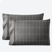 Two pillows on a white background with print pillowcases on them