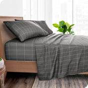 A bedroom with modern print sheets on the bed