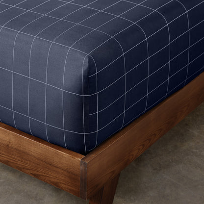 The corner of a mattress with a printed fitted sheet on it
