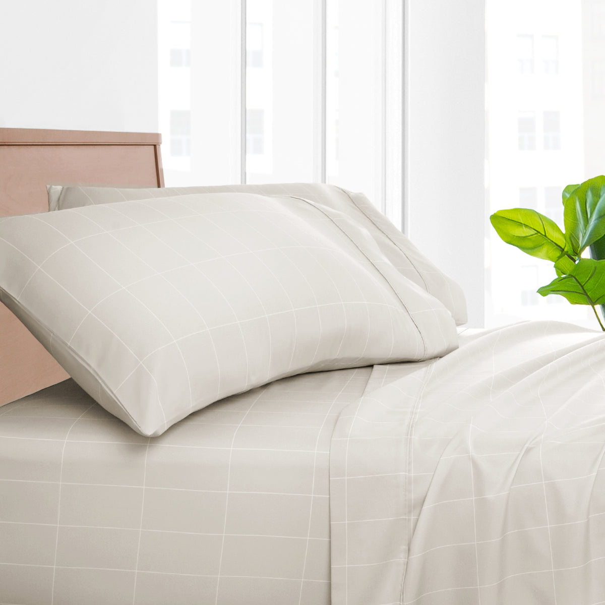 Printed bed sheet set on a bed with a white background