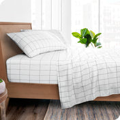 A bedroom with modern print sheets on the bed