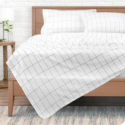 A modern bedroom with printed sheets on the bed