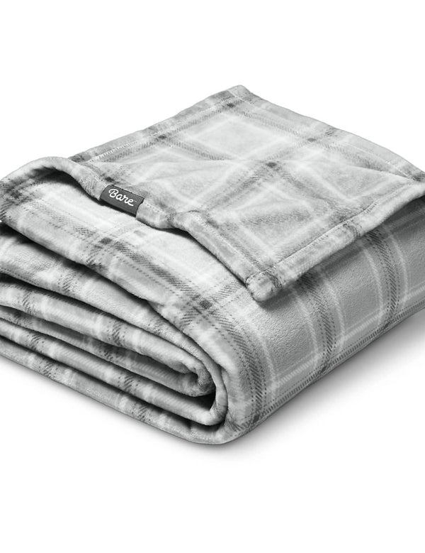 Microplush blanket laid out over a bed