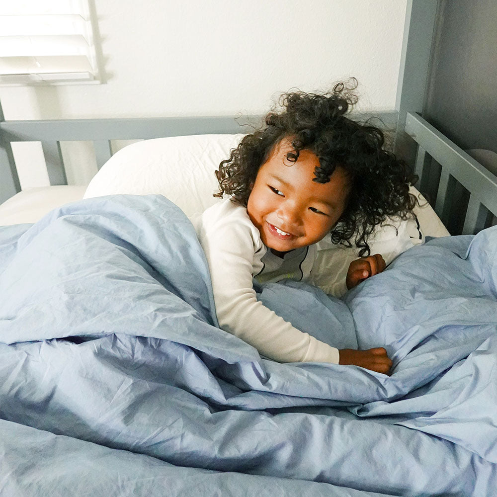 Baby Resting in Organic Blue Bedding